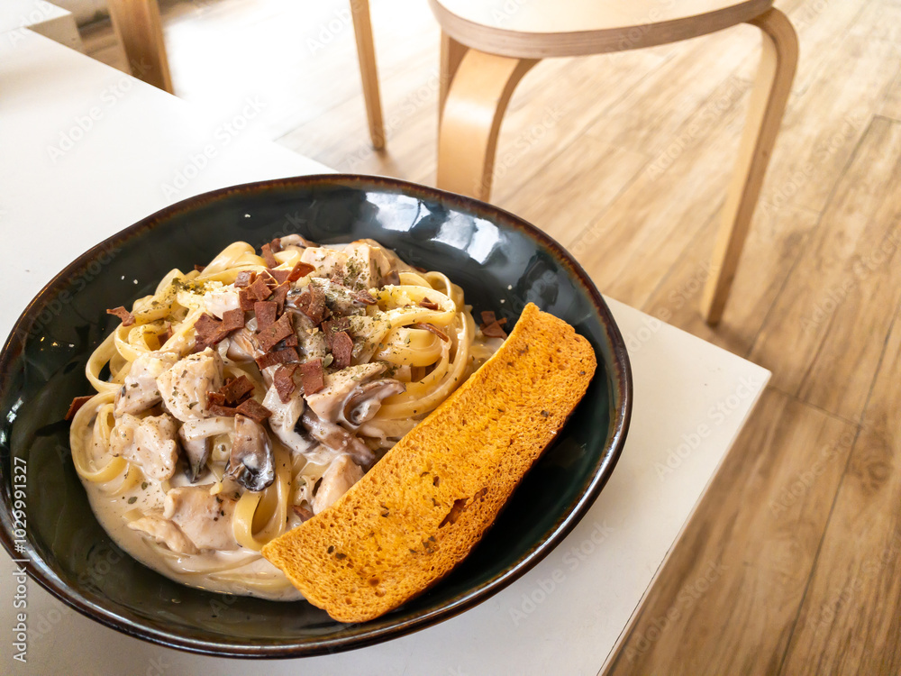 beef fetuccini carbonara with mushroom sauce on wooden table beef fetuccini carbonara with mushroom sauce on wooden table