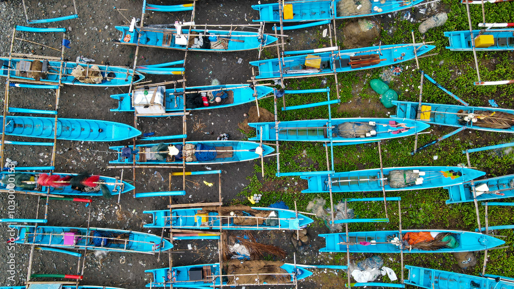 Fototapeta premium High-Angle Footage: Cluster of Fishing Vessels at Anchor