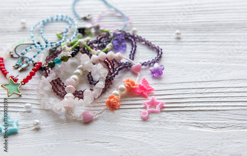 Colorful handmade jewelry laid out on a wooden surface showcasing various beads and charms in a creative arrangement photo