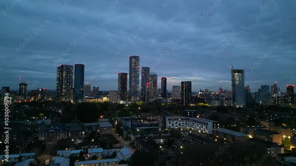 Aerial View of Illuminated Greater Manchester Central City During Cloudy Night, Northwest of England Great Britain. The High Angle Footage Was Captured During Midnight over Downtown of Manchester City Aerial View of Illuminated Greater Manchester Central City During Cloudy Night, Northwest of England Great Britain. The High Angle Footage Was Captured During Midnight over Downtown of Manchester City