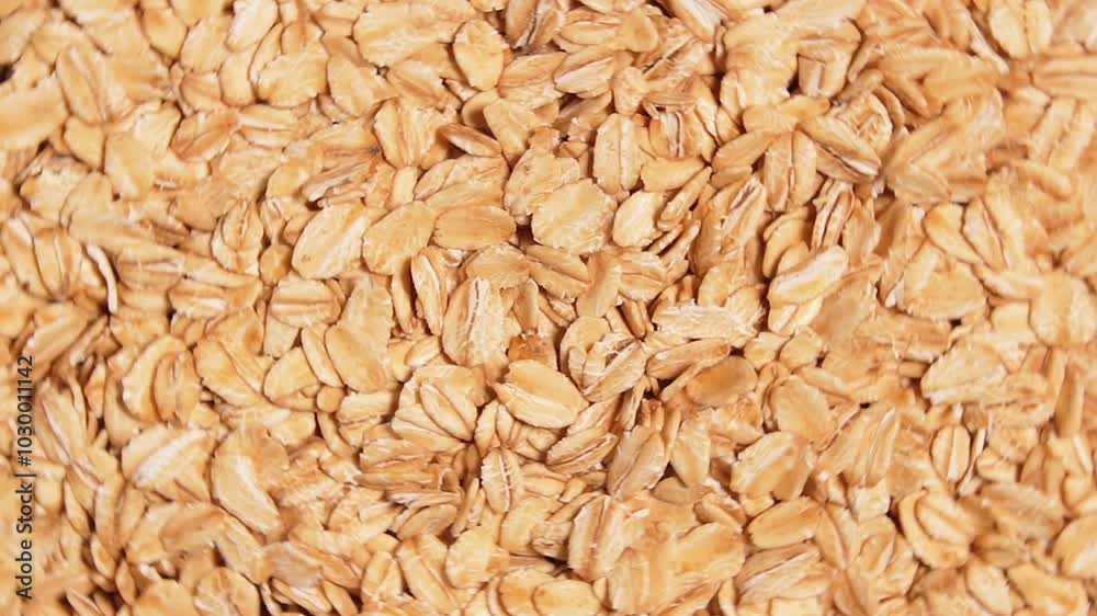 Oat Flakes Background Rotating Left - Top View. Scattered Dry Oat Flakes. Healthy Breakfast and Diet Eating Ingredients Oat Flakes Background Rotating Left - Top View. Scattered Dry Oat Flakes. Healthy Breakfast and Diet Eating Ingredients