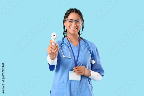Smiling female nurse in blu...