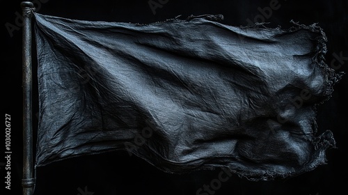 A black flag flutters against a stark black backdrop.