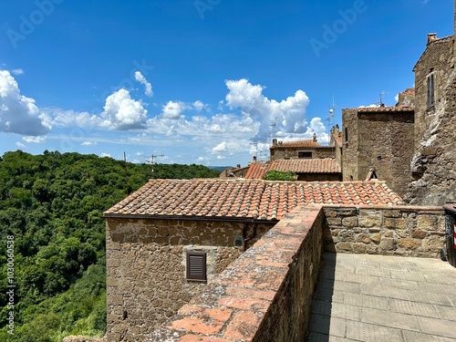 Photo captures a summer sunset over a Tuscan medieval city, showcasing stunning landscapes and intricate architectural details that highlight the timeless charm of Tuscany.