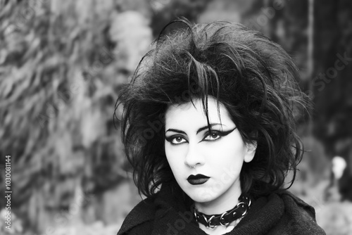 Portrait of Dark gothic fashion youg woman with black makeup, black lipstick and nose piercing. Italian beautiful brunette girl. Dark lady. Dark girl. Trad goth girl. Black and white photo. Close-up