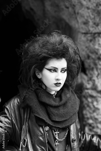 Portrait of Dark gothic fashion youg woman with black makeup, black lipstick and nose piercing. Italian beautiful brunette girl. Dark lady. Dark girl. Trad goth girl. Black and white photo. Close-up