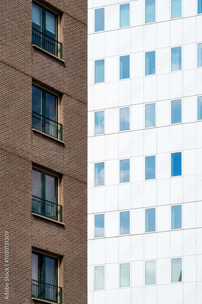 The image displays a striking contrast between a traditional brown brick building and a sleek modern white facade, symbolizing the intersection of old and new architecture. The image displays a striking contrast between a traditional brown brick building and a sleek modern white facade, symbolizing the intersection of old and new architecture.