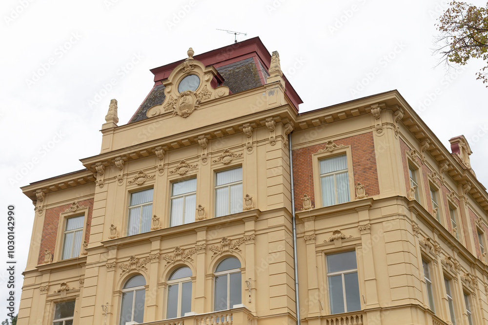 A very large and towering building that features a prominent clock positioned on top of it, making it a significant landmark in the area A very large and towering building that features a prominent clock positioned on top of it, making it a significant landmark in the area