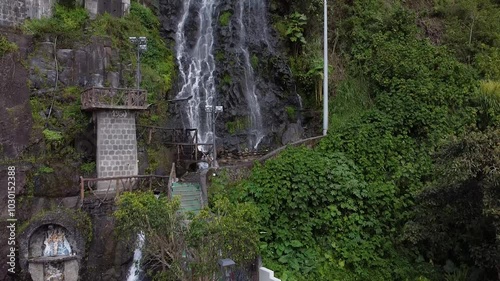 Aerial waterfall in Banos, Ecuador. Waterfall reveal in South America mountain town edge of the amazon rainforest with lots of waterfalls, jungle. photo