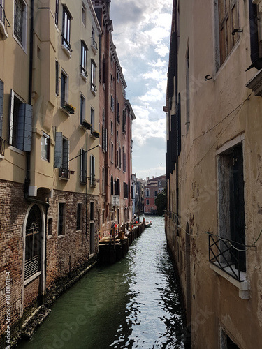 Narrow canal and old buildings in Venice, Italy. photo