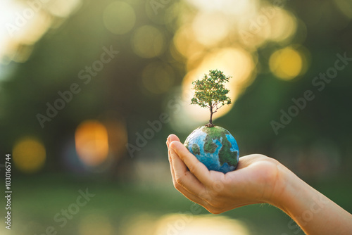 Fototapeta Naklejka Na Ścianę i Meble -  World environment day, Hands of woman holding globe with tree for ESG on green tree light bokeh background, co2, and net zero, ecology concept, earth day, Better Environment, copy space.