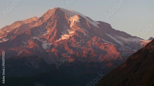 Sunset light illuminating Mount Rainier with glaciers and rugged terrain, Washington State, USA