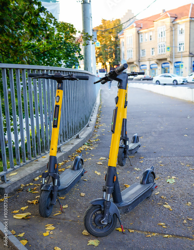 City transport, scooter, electric scooter parked on the sidewalk. Urban electric transport for fast movement around the city without traffic jams