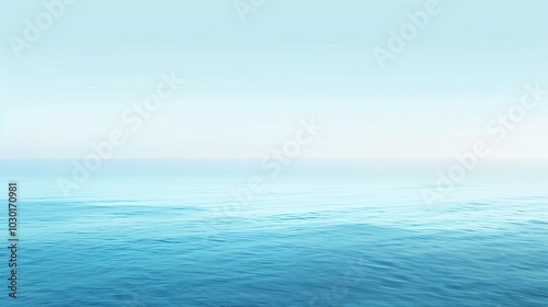 A serene seascape with calm, blue water and a clear sky.