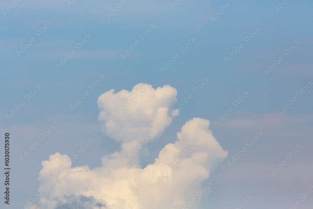 Soft white clouds against a clear blue sky creating a serene nature background or wallpaper Soft white clouds against a clear blue sky creating a serene nature background or wallpaper