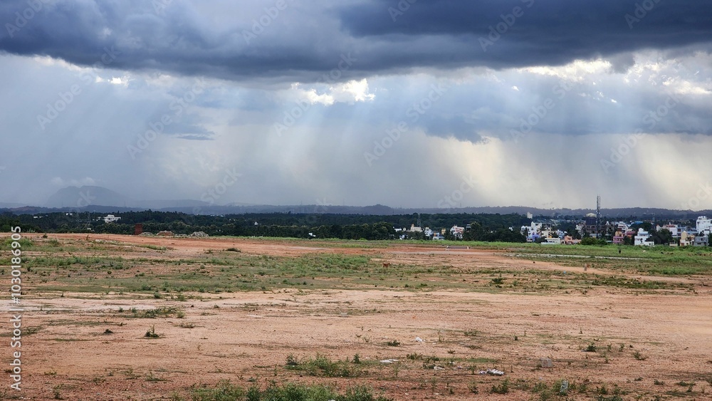 Scenic shot of monsoon rains falling from the clouds from a distance in Bengaluru, India Scenic shot of monsoon rains falling from the clouds from a distance in Bengaluru, India