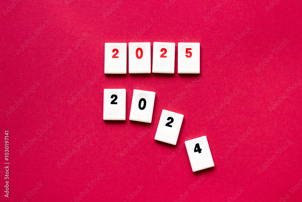 chips with red number 2025 above other chips with numbers 2024 falling apart, 2025 coming concept chips with red number 2025 above other chips with numbers 2024 falling apart, 2025 coming concept