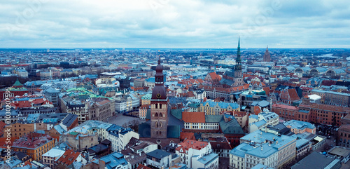 Aerial view of Riga showcasing historic architecture and colorful rooftops under a cloudy sky #1030207595