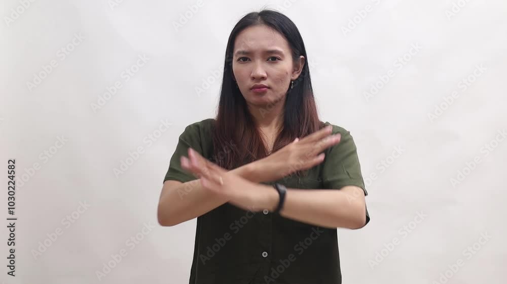 Young Asian woman is denying and disagreeing looking at the camera. Isolated on white background Young Asian woman is denying and disagreeing looking at the camera. Isolated on white background