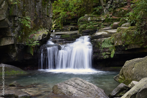 color detail photography of beautiful small waterfall in the forest