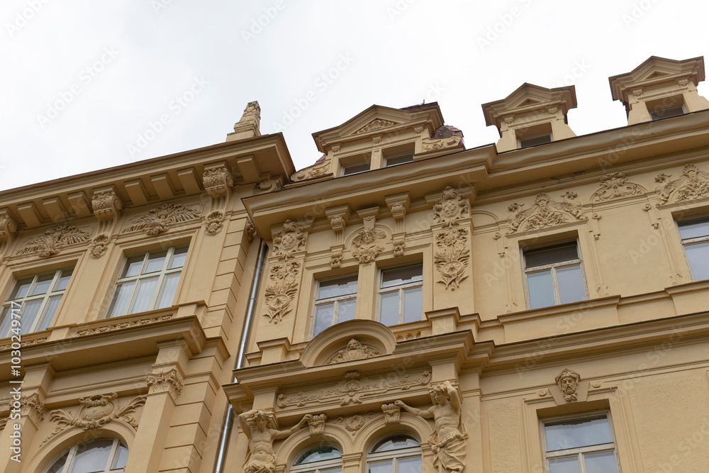 As I gaze upward at the towering large building that boasts a multitude of windows, I cant help but admire its grand facade As I gaze upward at the towering large building that boasts a multitude of windows, I cant help but admire its grand facade