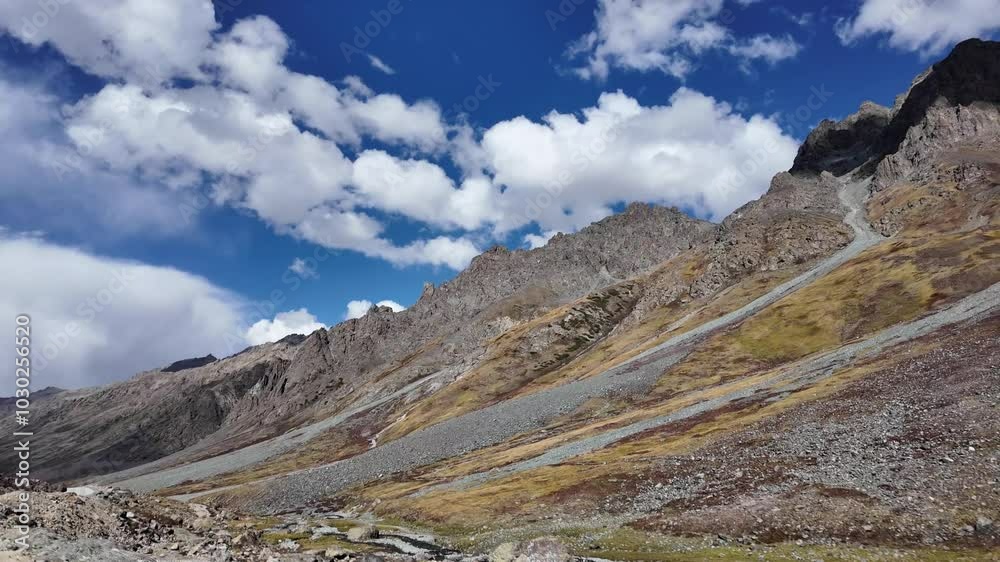 4K Mountain Landscape Front and Side Moving View Along a Concrete Road, Sunlight Illuminating Green Mountains, Dramatic Dark Light at the Peaks, and Sun Shining Through Dark and White Clouds,River