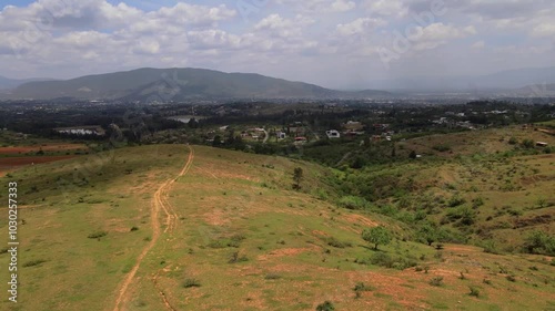 Wallpaper Mural Aerial drone footage over cow fields with a town and mountains in the background on a cloudy day, Oaxaca, Mexico Torontodigital.ca
