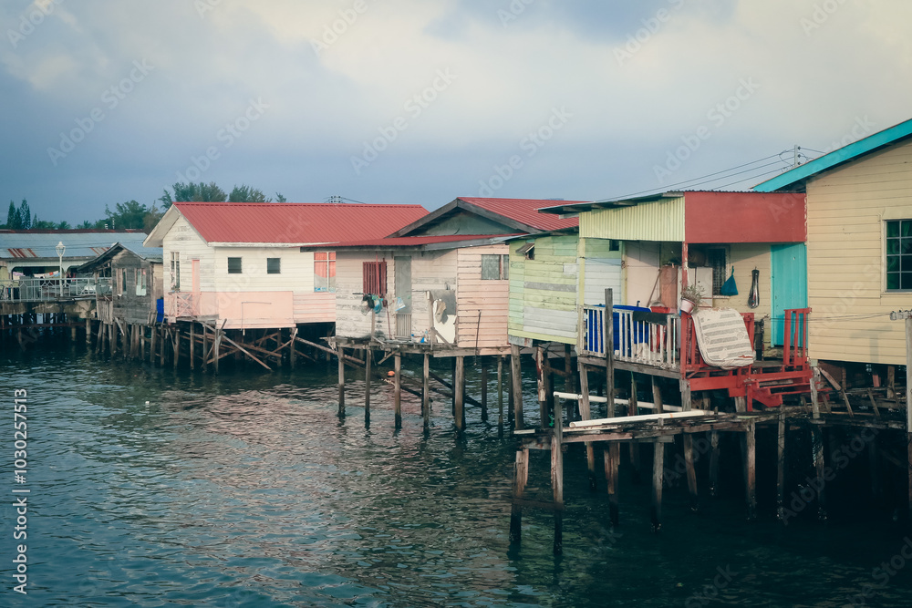 Colorful stilt houses along the waterfront in Kota Kinabalu during a cloudy afternoon Colorful stilt houses along the waterfront in Kota Kinabalu during a cloudy afternoon