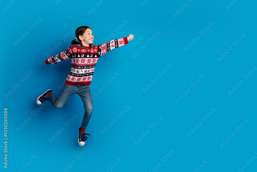 Photo of excited cheerful girl wear red sweater hurry store christmas sale empty space isolated on blue color background Photo of excited cheerful girl wear red sweater hurry store christmas sale empty space isolated on blue color background