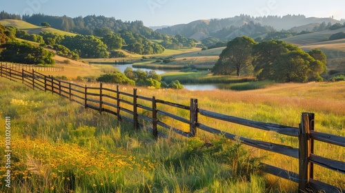 A picturesque sunrise over a peaceful meadow with vibrant flowers and a rustic wooden fence.