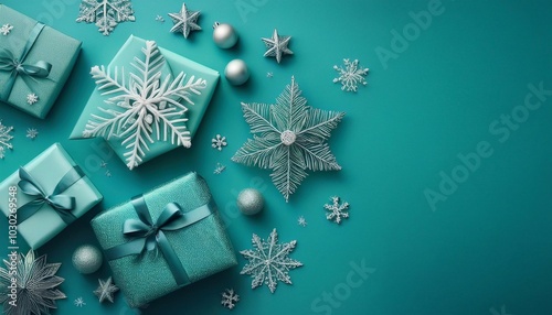 Christmas background with snowflakes and gifts on flat turquoise surface with space for text