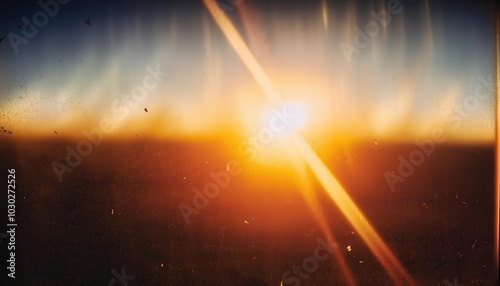 Warm Lens Flare through a smeared glas shot on 8mm Film with some film fragments grunge texture Bokeh