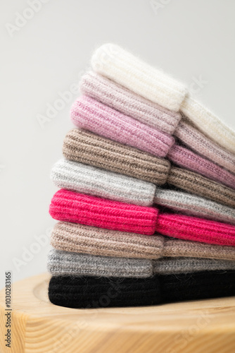 Collection of stylish knitted hats (pink, beige, black, white, gray, red) Composition of lined hats. A set of autumn - winter hat accessories