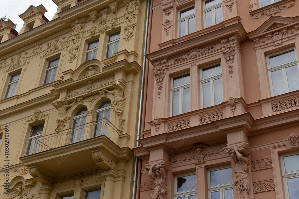 There is a tall building featuring numerous windows located right next to another impressive structure that is also filled with many windows There is a tall building featuring numerous windows located right next to another impressive structure that is also filled with many windows
