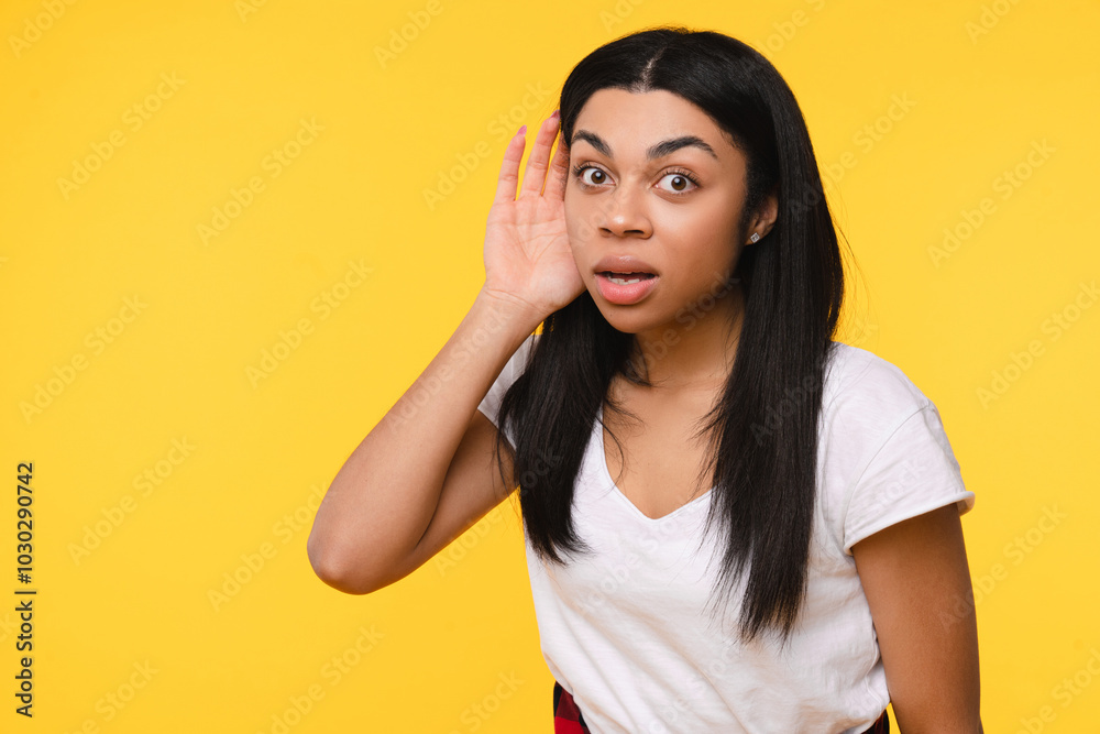Curious nosy African American girl woman female student touch ear doing eavesdropping look novelty try to hear you overhear listening intently hot news isolated on bright yellow background empty space Curious nosy African American girl woman female student touch ear doing eavesdropping look novelty try to hear you overhear listening intently hot news isolated on bright yellow background empty space