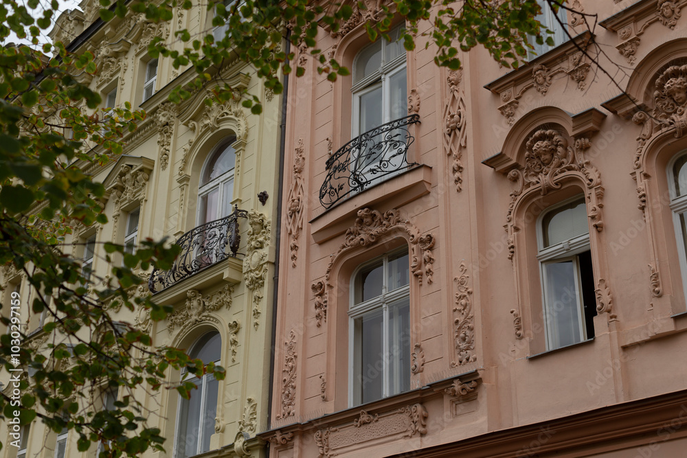 A detailed closeup shot of a large building that features numerous windows as well as multiple balconies that adorn its exterior A detailed closeup shot of a large building that features numerous windows as well as multiple balconies that adorn its exterior