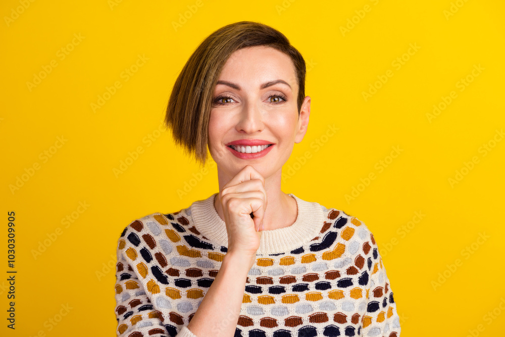 Portrait of minded positive woman touch hand chin think thoughts isolated over yellow color background Portrait of minded positive woman touch hand chin think thoughts isolated over yellow color background