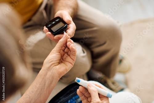 A senior couple shares a heartfelt moment as the wife assists her husband with diabetes management.