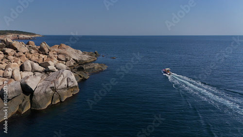 Tourist Boat next to the rocks