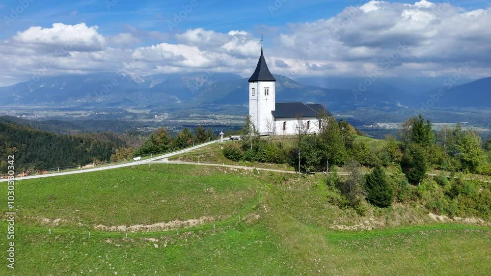 Majestic aerial view of Church of Saint Primus and Felician sitting on top of the world of verdant backdrop in Jamnik Slovenia Majestic aerial view of Church of Saint Primus and Felician sitting on top of the world of verdant backdrop in Jamnik Slovenia