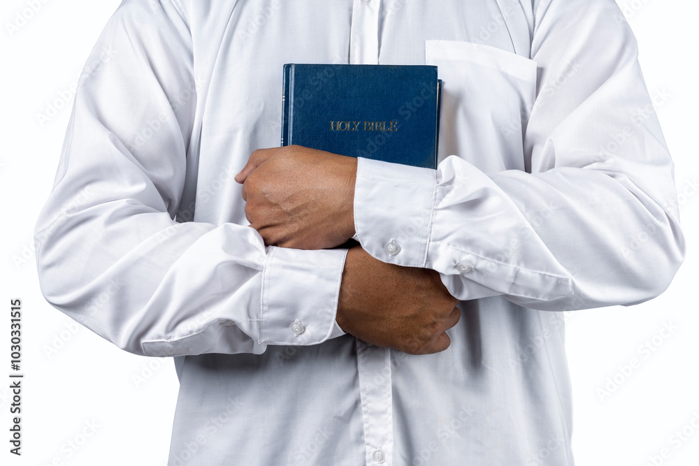 Christian man holding a holy bible in his hand. Symbol of faith in God, Christianity Feast Christian man holding a holy bible in his hand. Symbol of faith in God, Christianity Feast