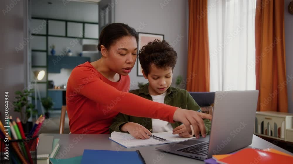 African American family at home education mother mom female woman girl helping studying son help learning online task internet class laptop study together kid child boy discuss exercise learn teaching African American family at home education mother mom female woman girl helping studying son help learning online task internet class laptop study together kid child boy discuss exercise learn teaching