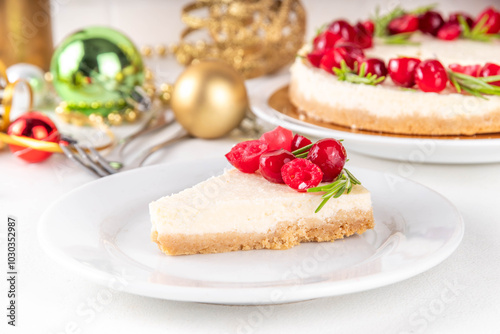 Tasty Christmas cheesecake with cranberries and rosemary decorated like Christmas wreath. Simple elegant winter white dessert 