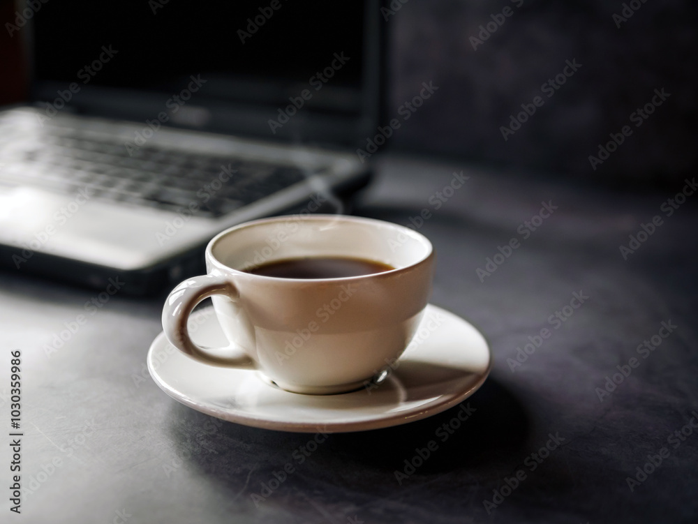 Relax during business work concept, americano coffee cup and black coffee cup aromatic and laptop computer in morning Relax during business work concept, americano coffee cup and black coffee cup aromatic and laptop computer in morning