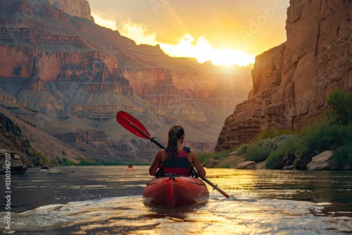 kayaking in the grand canyon at sunset, back view of woman kayaker on river with red kayak and oars,