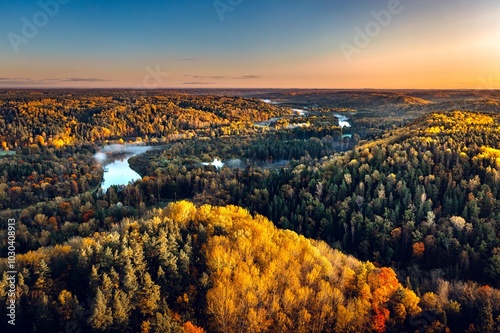 Obraz na płótnie Colorful sunrise over the Gauja National park valley. Sigulda city panorama from drone with forest in autumn colors. w salonie