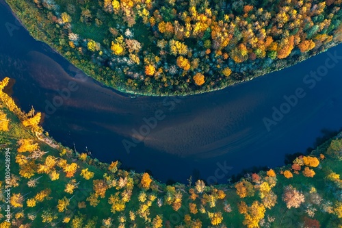 Obraz na płótnie Colorful sunrise over the Gauja National park valley. Sigulda city panorama from drone with forest in autumn colors. w salonie