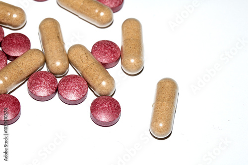 Vitamin Capsules and Pills on a White Background For Medication round and long shaped