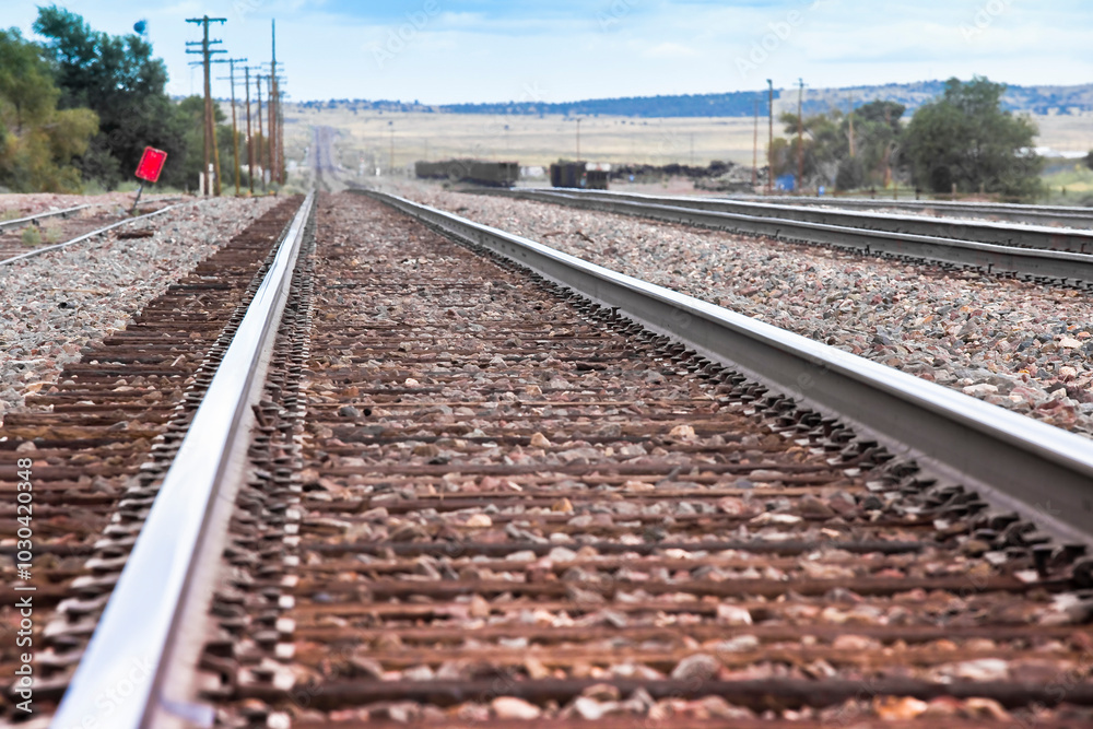 Fototapeta premium American railway with oak cross beams against a stone gravel (USA)
