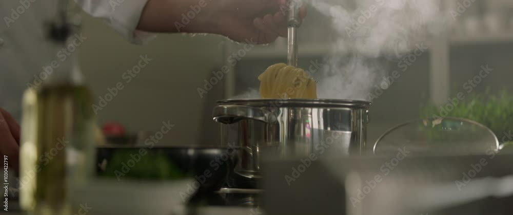 cooking pasta in a pot of boiling water. Culinary show cinematic footage slow motion. Foodstyle, Traditional pasta spaghetti, kitchen